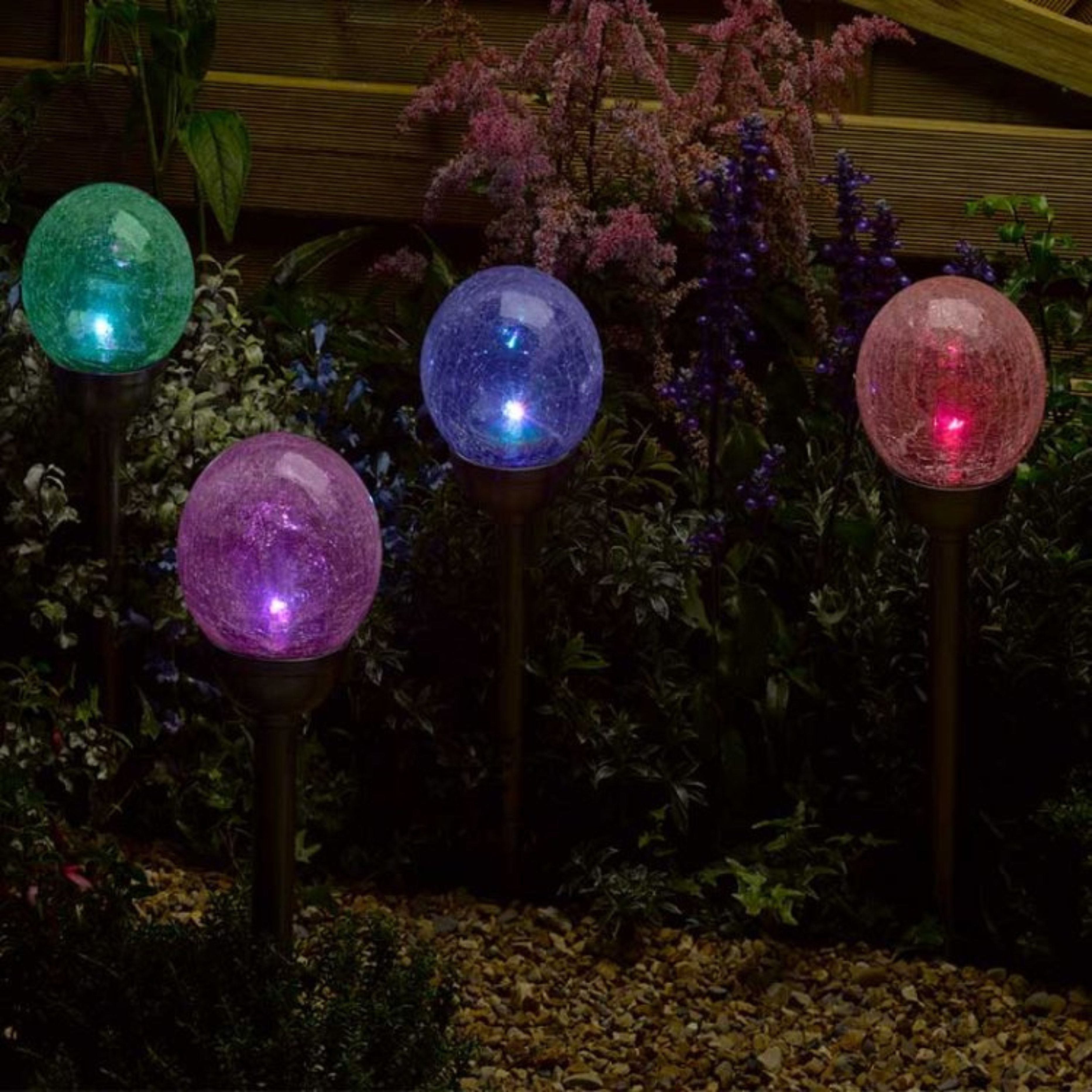 Colorful garden lights on stakes in a garden setting